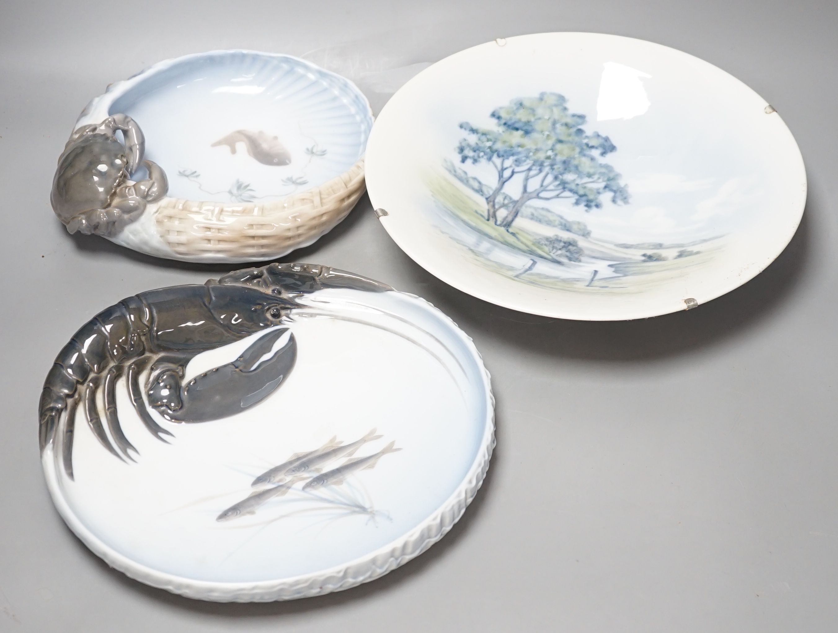 Three Royal Copenhagen dishes, one decorated with a crab, another with a lobster